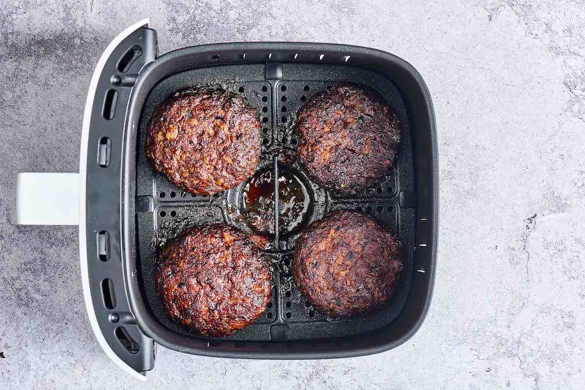 air fried hamburgers in air fryer basket.