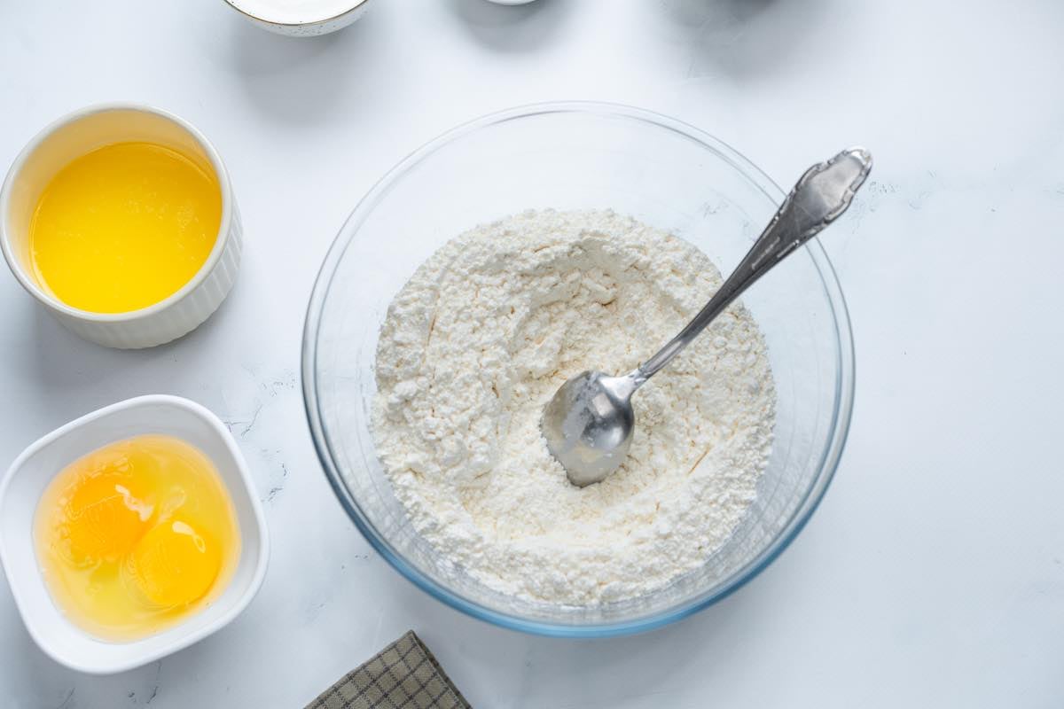 flour, baking powder, and baking soda in a bowl.
