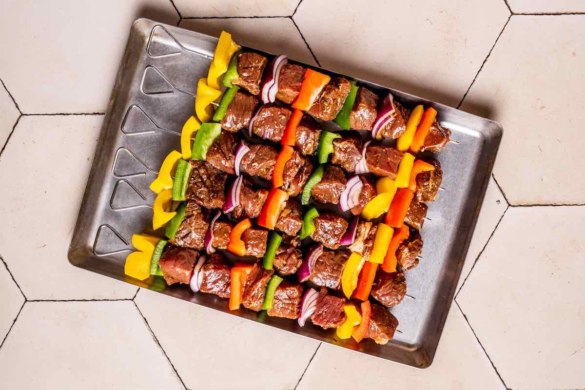 skewered steak chunks with vegetables.