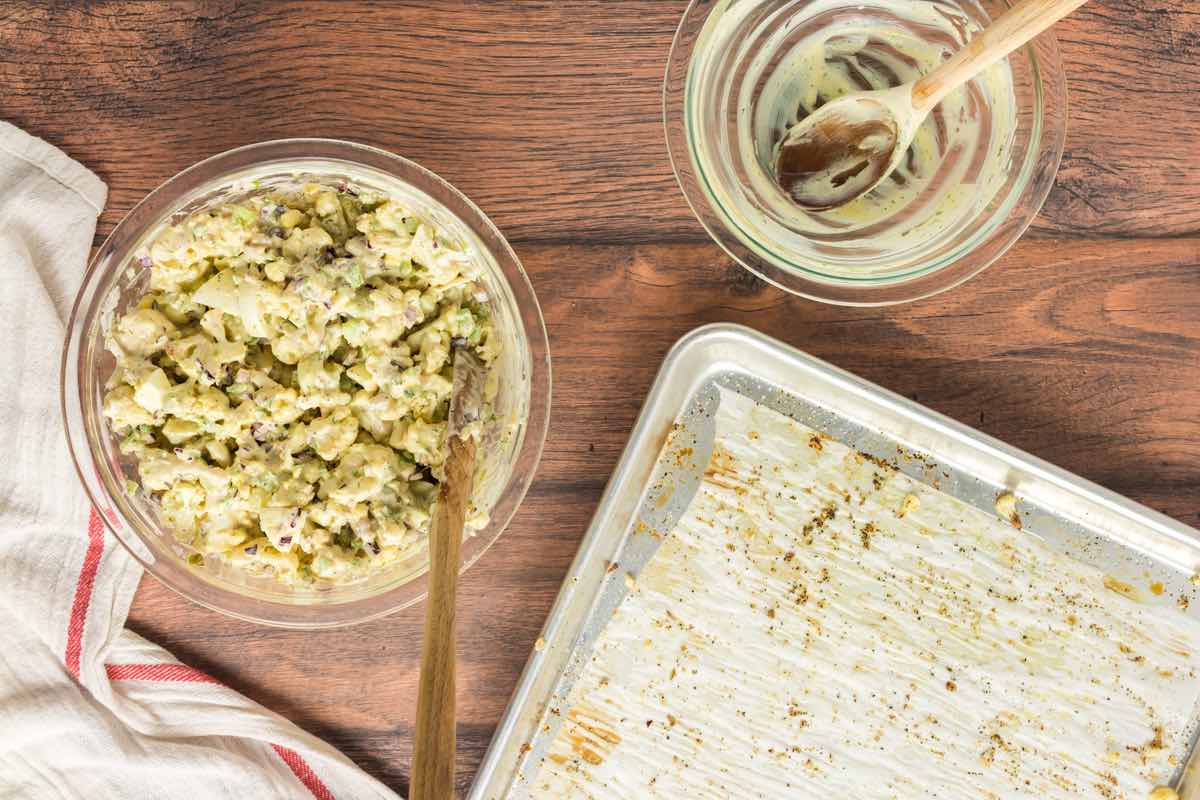 dressing mixed with cauliflower salad in a bowl.