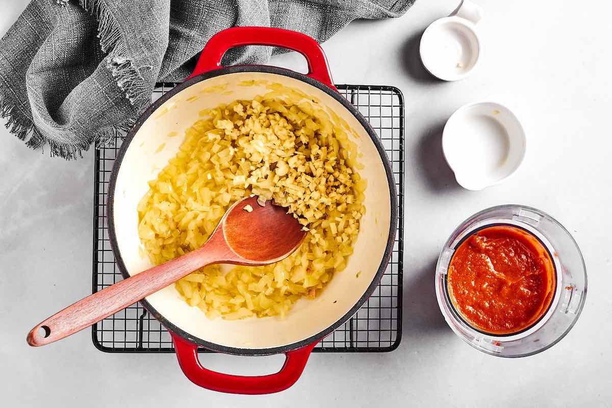 onion, garlic, and ginger sauteing in a pot.