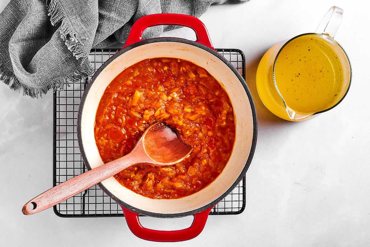 blended tomatoes, curry spices, and chicken broth added to pot.