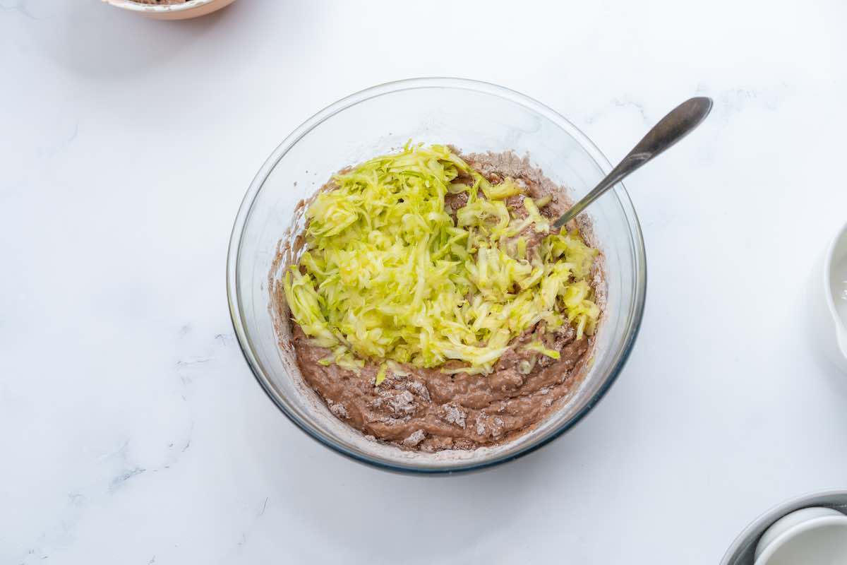 zucchini cake batter with shredded zucchini added in.