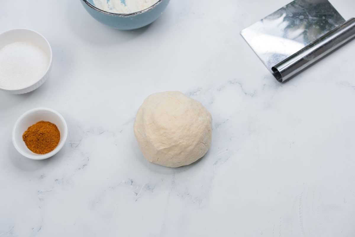 ball of dough on a floured surface.