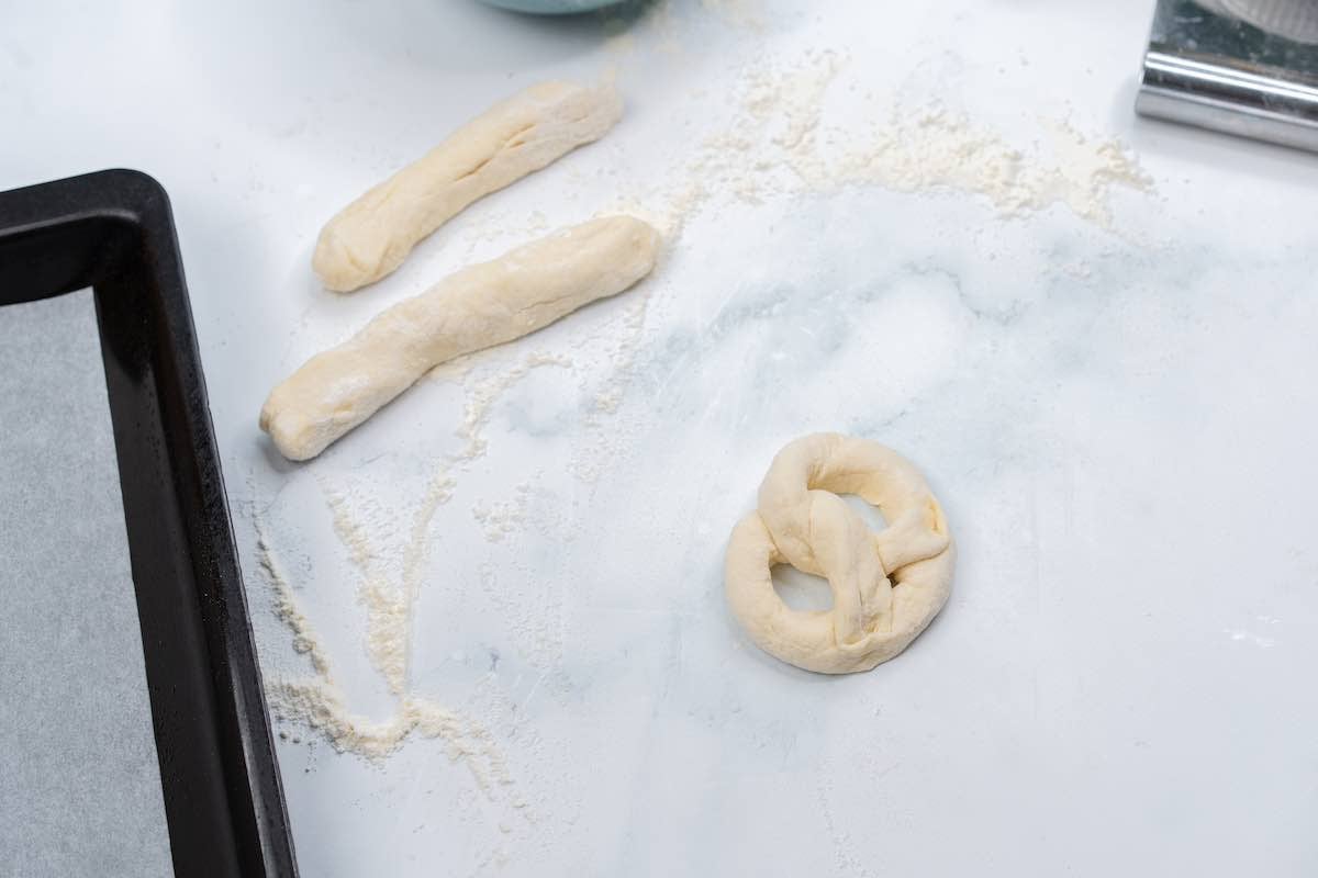 shaping dough into soft pretzels.