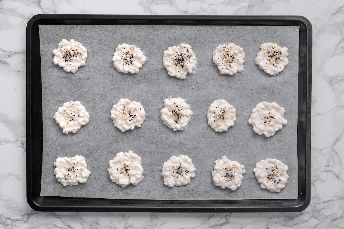 mounds of cottage cheese on a baking sheet with seasoning on top.