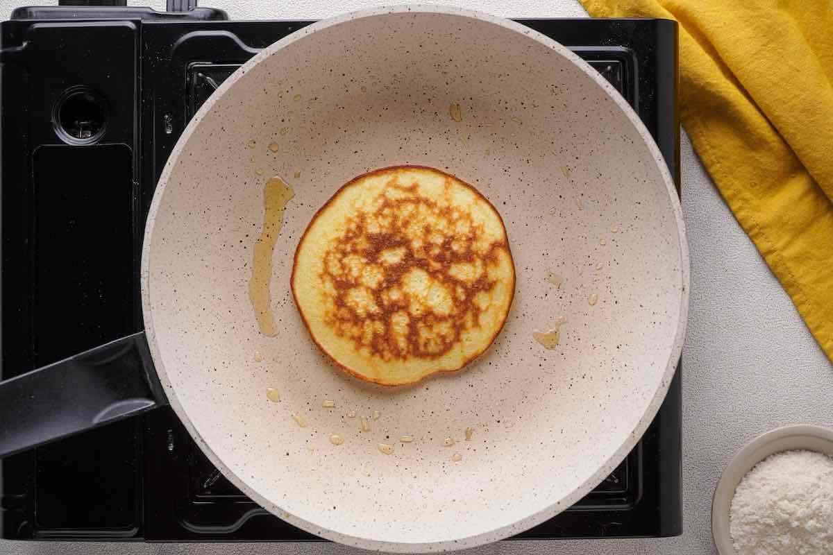 cottage cheese pancakes cooking on a skillet.
