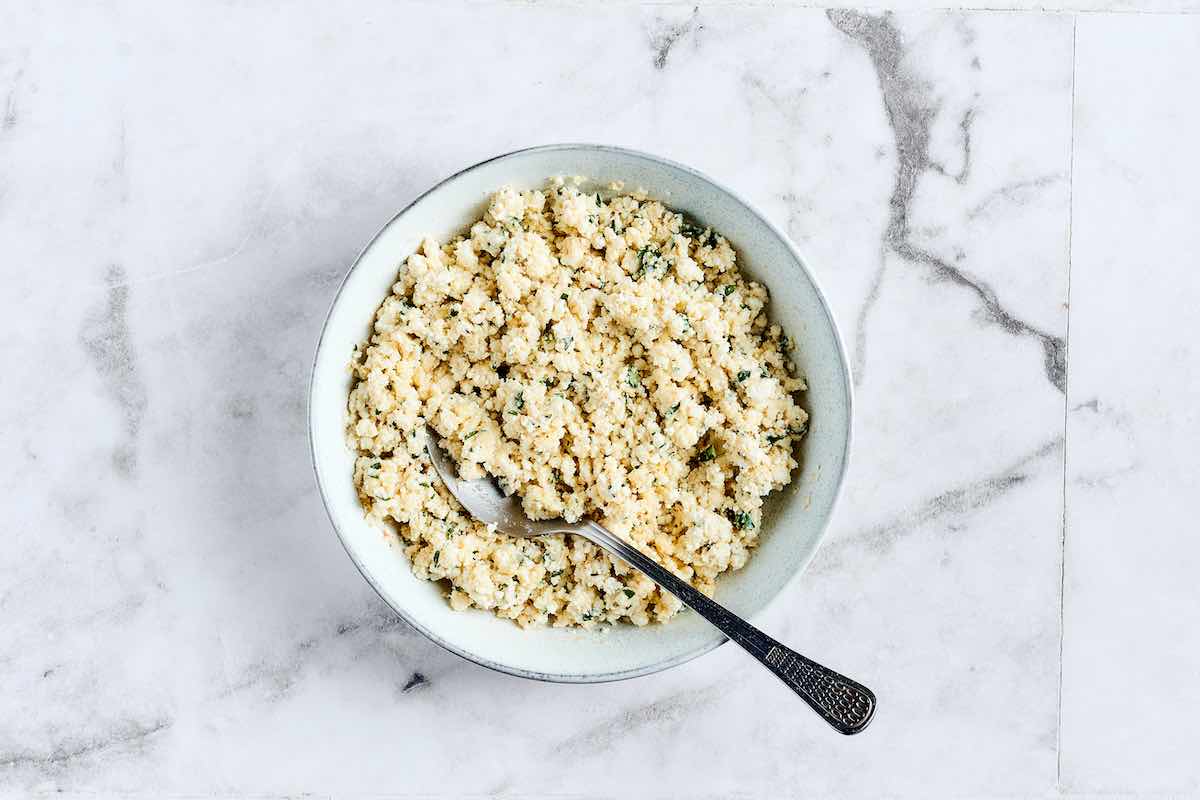 ricotta cheese, parmesan cheese, basil, salt, pepper, and egg in a bowl.