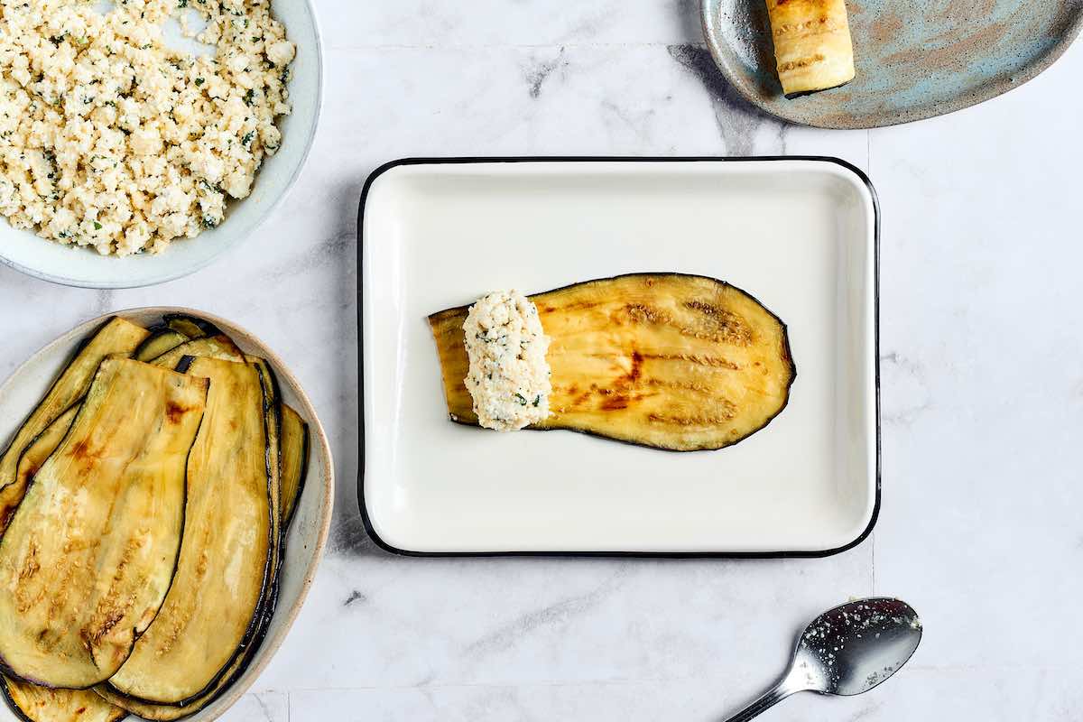 baked eggplant slices with ricotta cheese filling on top.