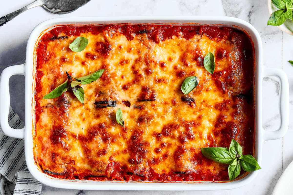 baked eggplant rollatini with basil leaves.
