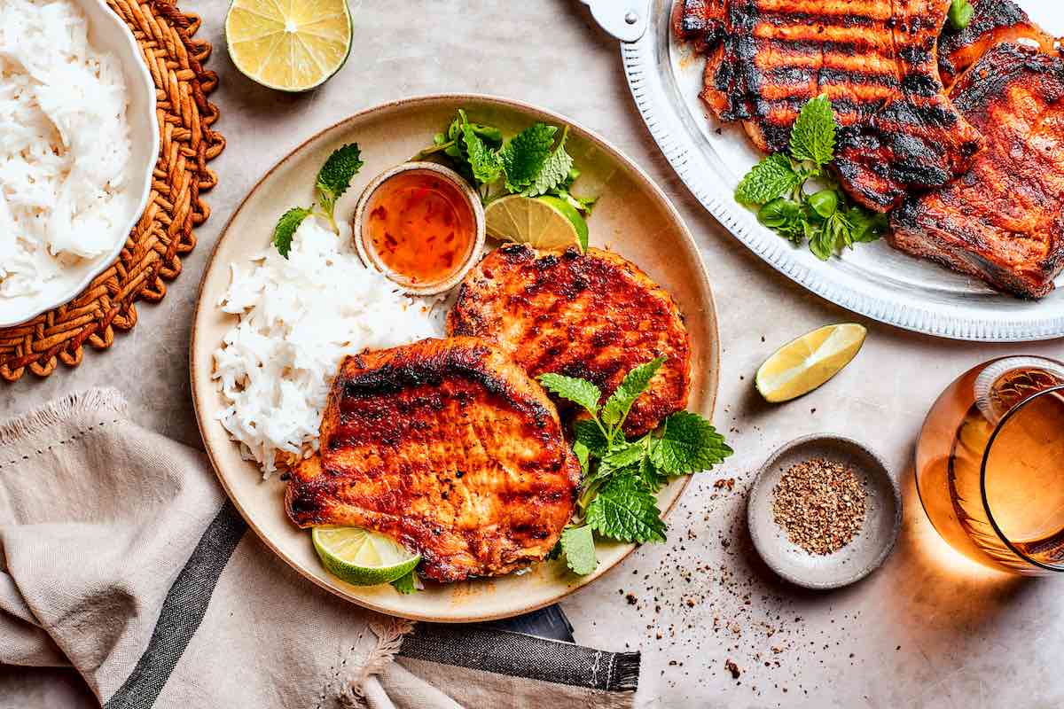 white rice with grilled boneless pork chops and sweet chili sauce.