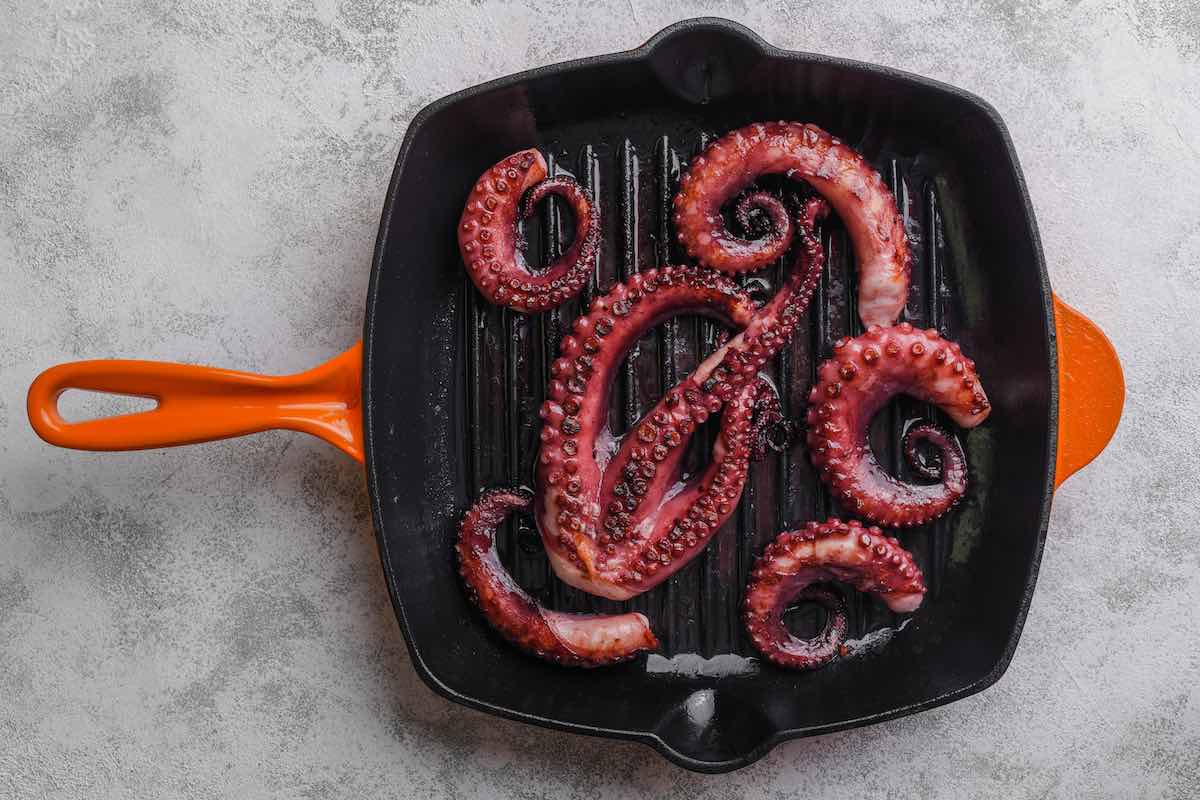 octopus grilling on a grill pan.