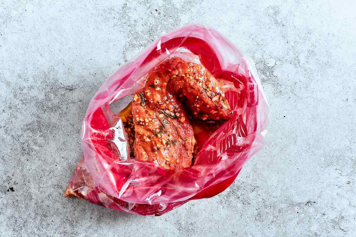 raw pork tenderloin in a bag with marinade.