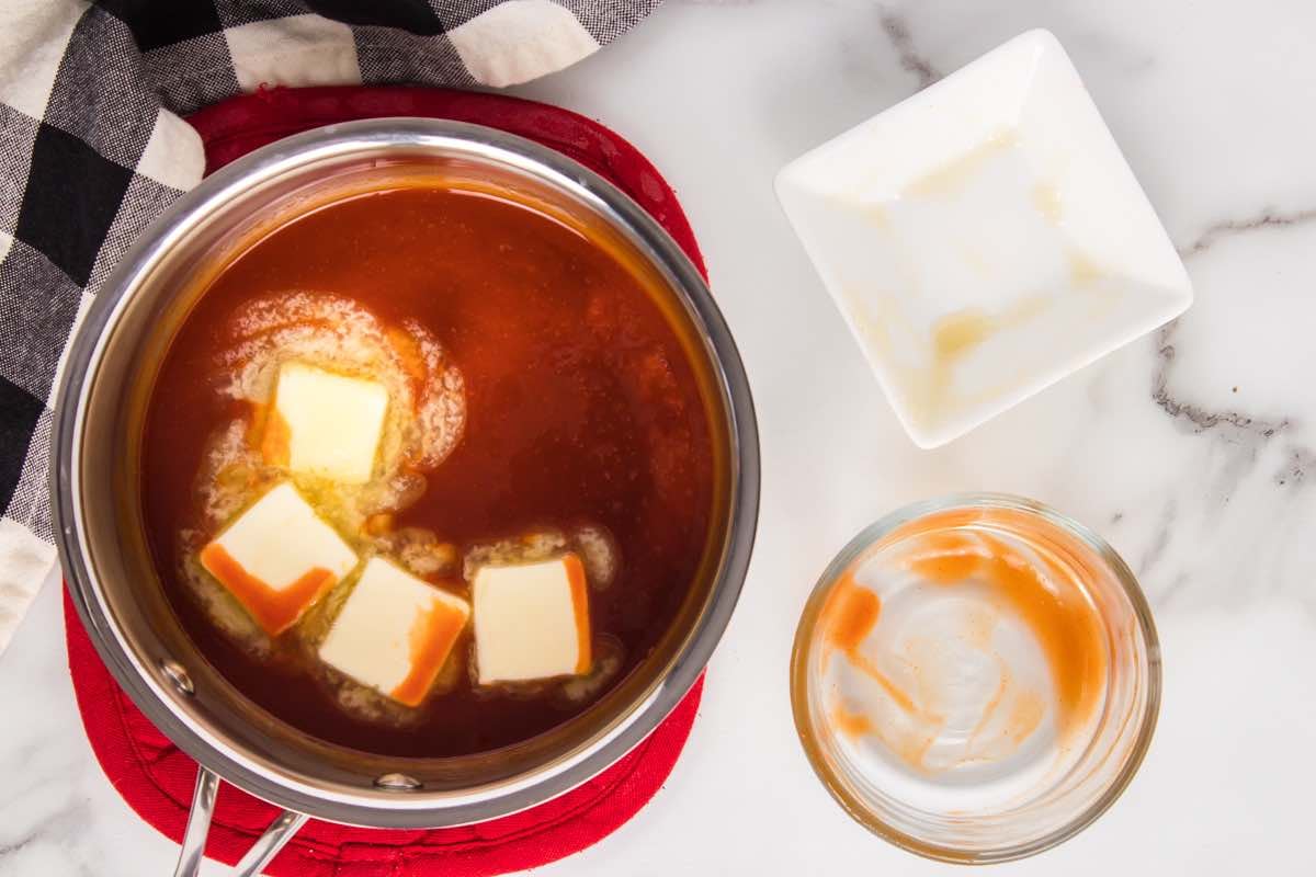 buffalo sauce ingredients in a saucepan with butter.