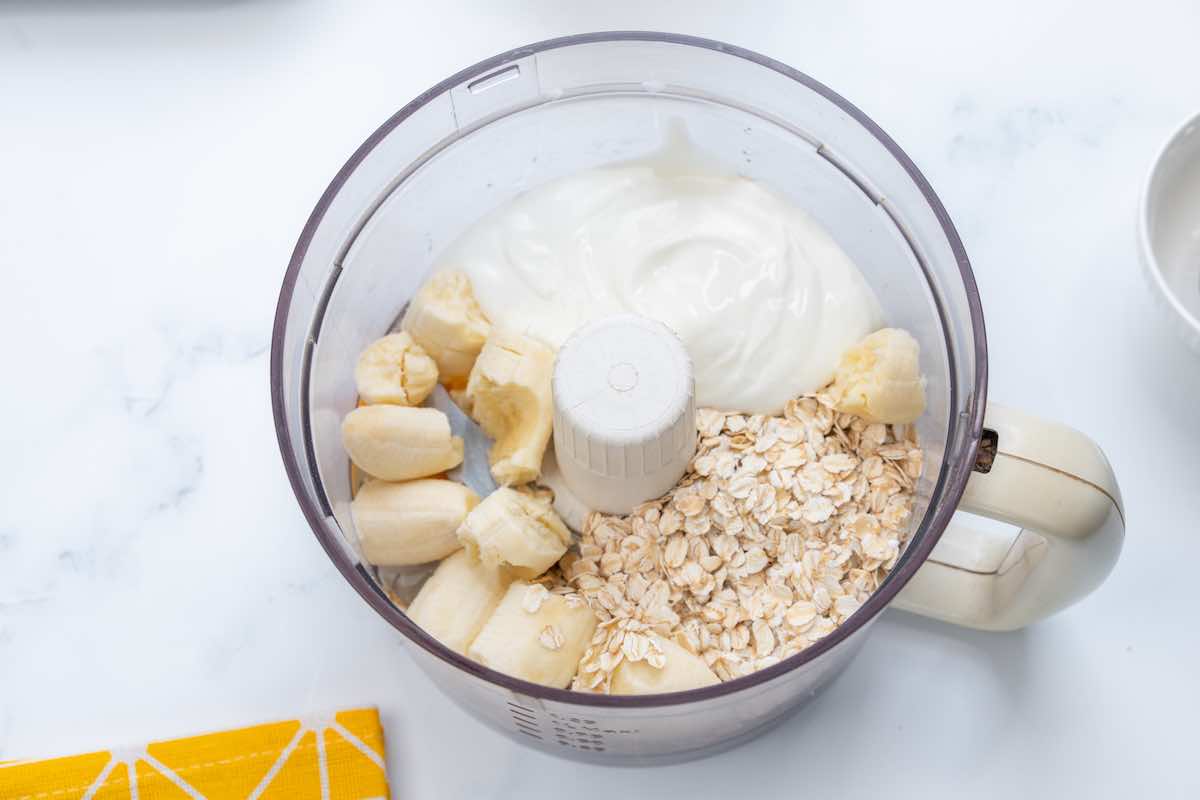 blender with bananas, oats, yogurt, and eggs.