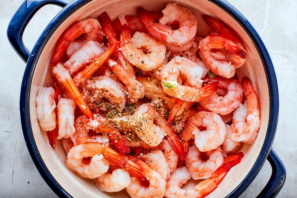 seasoned raw shrimp in a bowl.