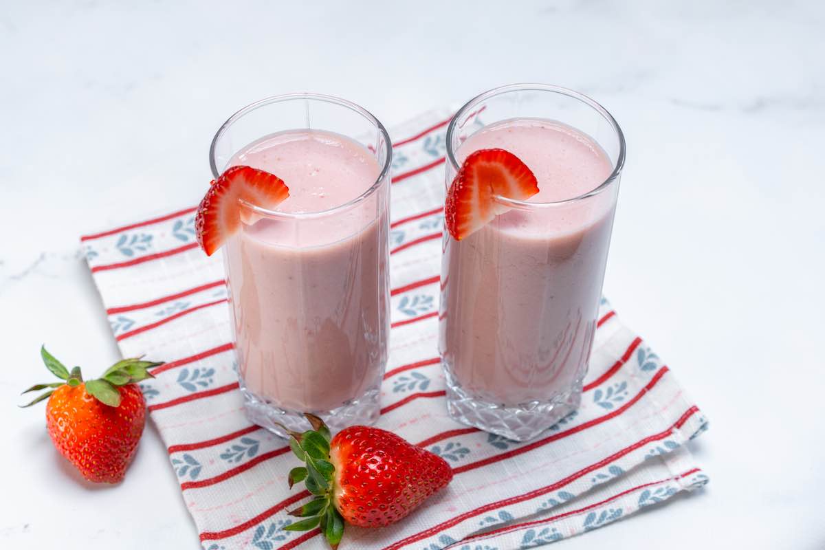 two glasses of homemade strawberry milk.