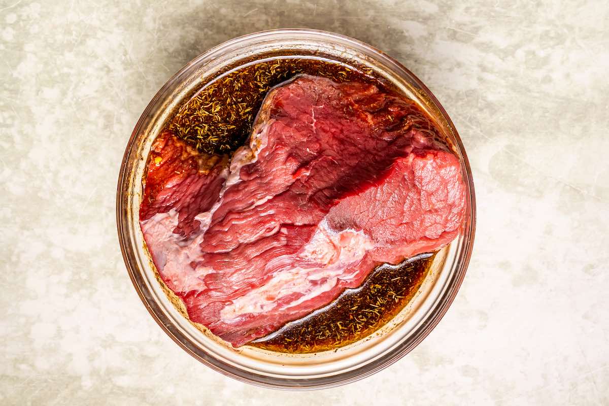 raw tri tip steak soaking in the marinade.