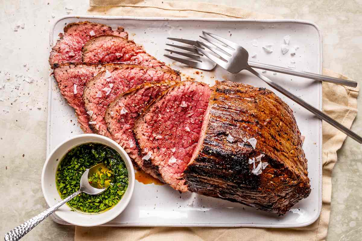 sliced tri tip steak with flaky salt on top.