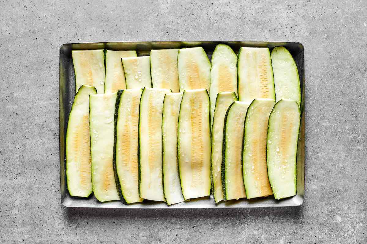 raw sliced zucchini with salt on top.