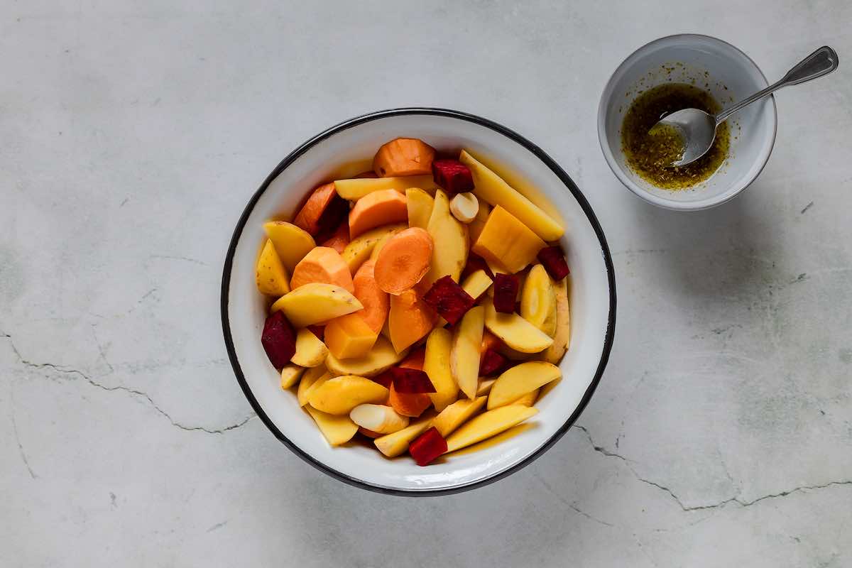 a bowl of raw root vegetables, chopped.