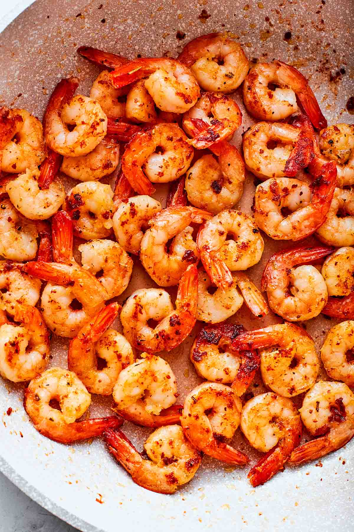 sauteed shrimp in a skillet.