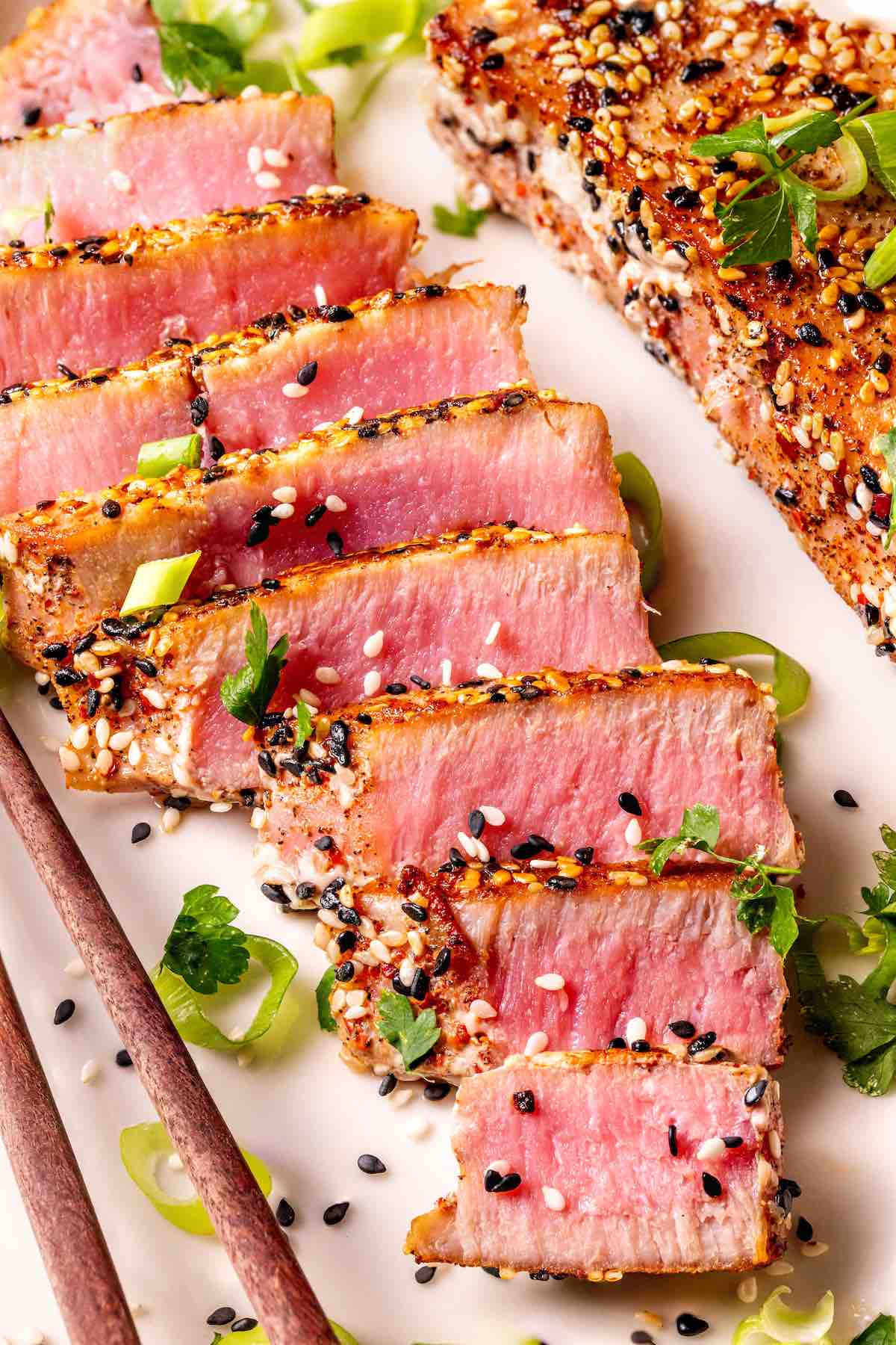 seared ahi tuna on a plate with sesame seeds on top.
