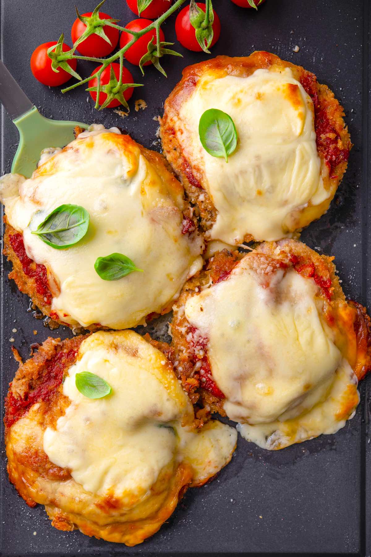 veal parmigiana with fresh basil on top.