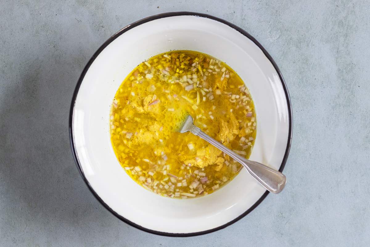 whisked dressing ingredients in a bowl.