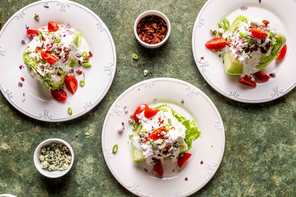 assembled wedge salads on plates.