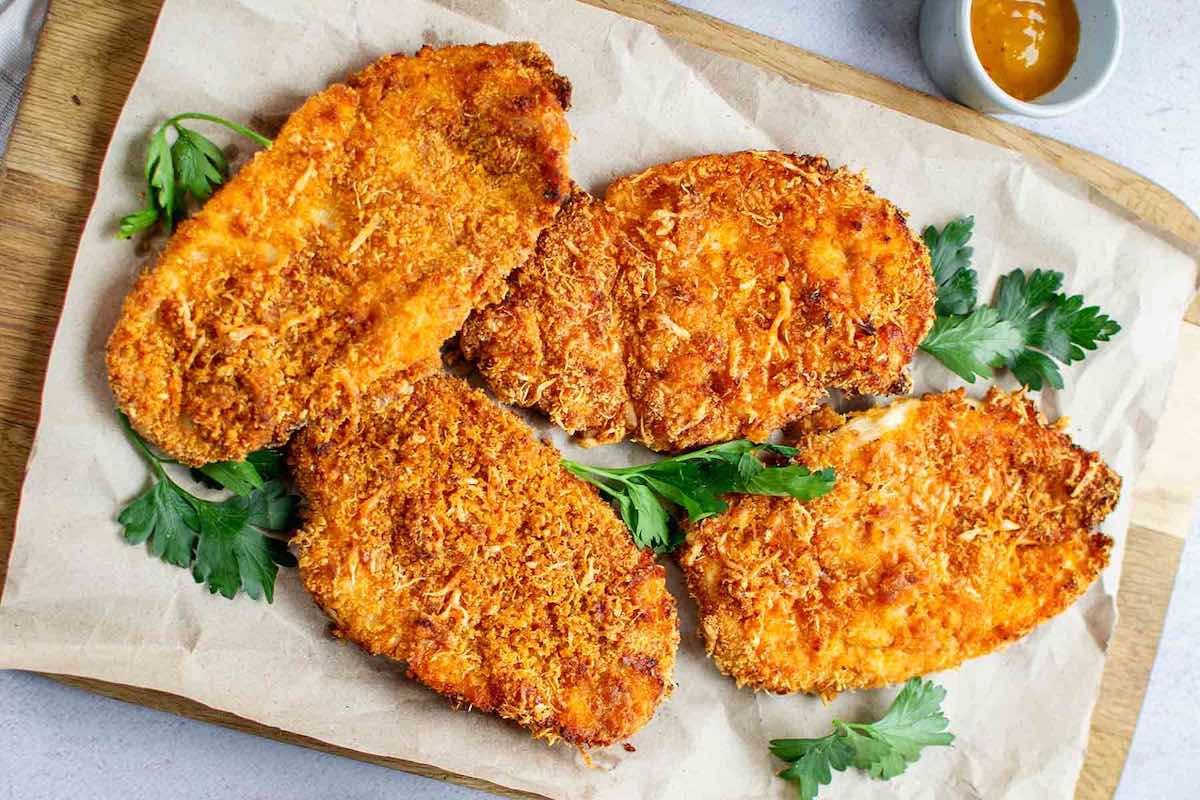air fried chicken cutlets on a serving tray.