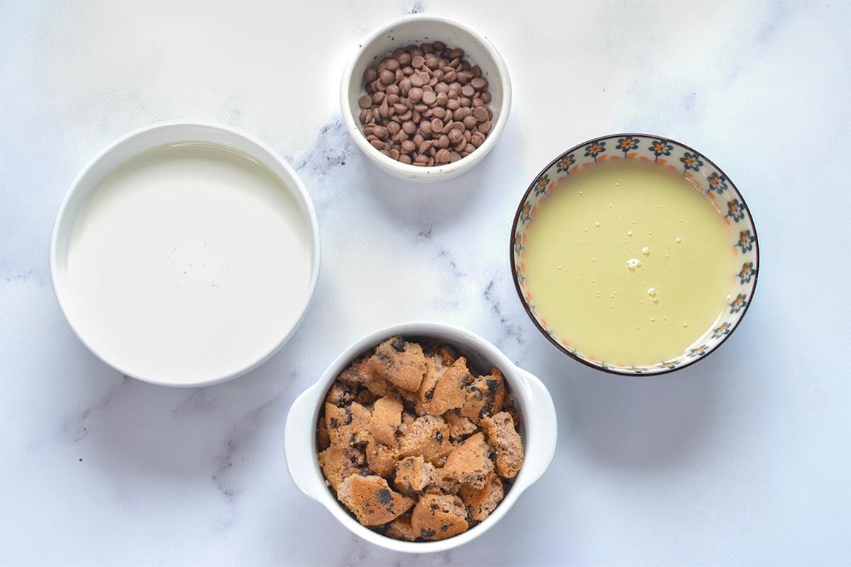 bowl of cream, condensed milk, chocolate chips, and cookie chunks.