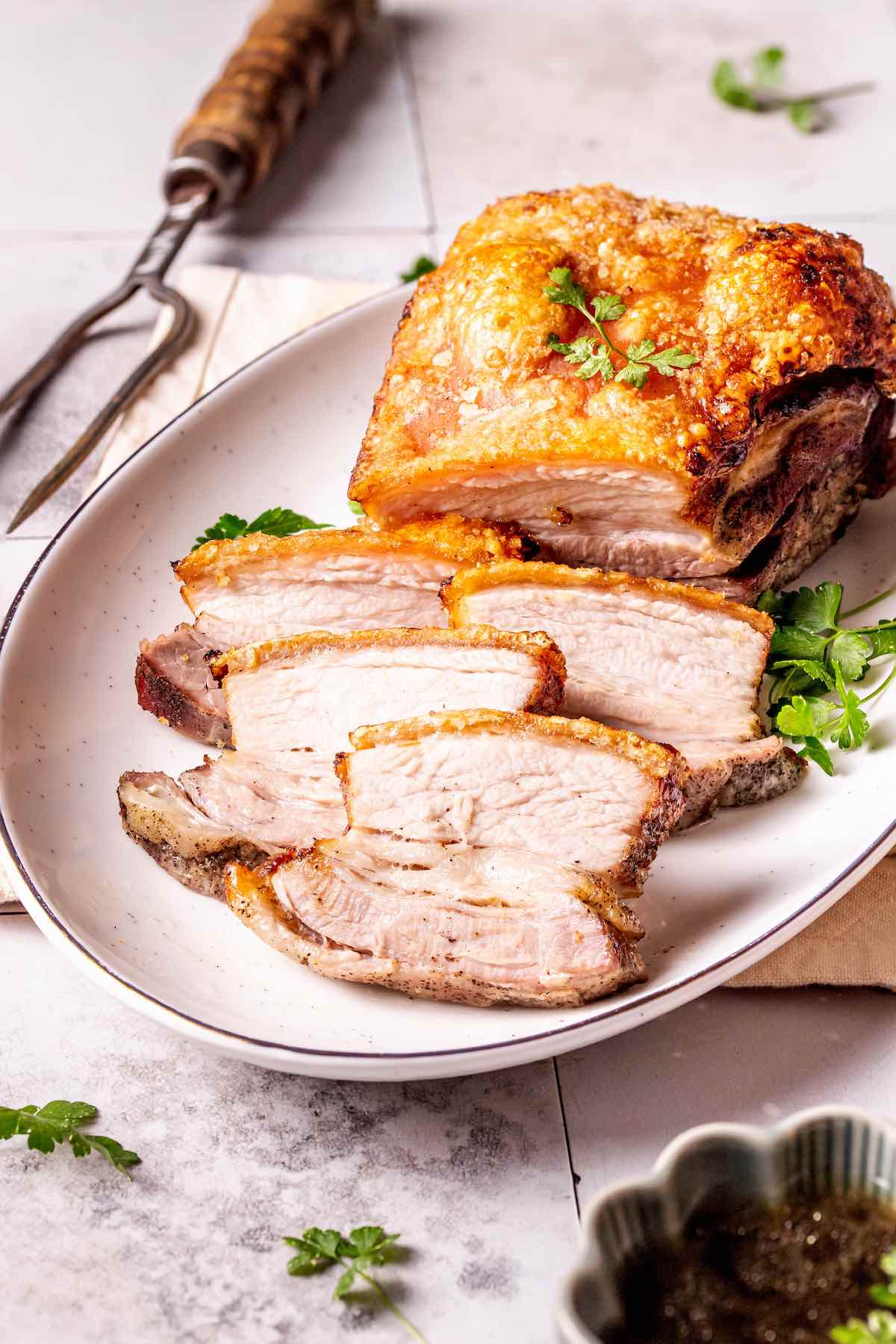 crispy pork belly on a serving plate.