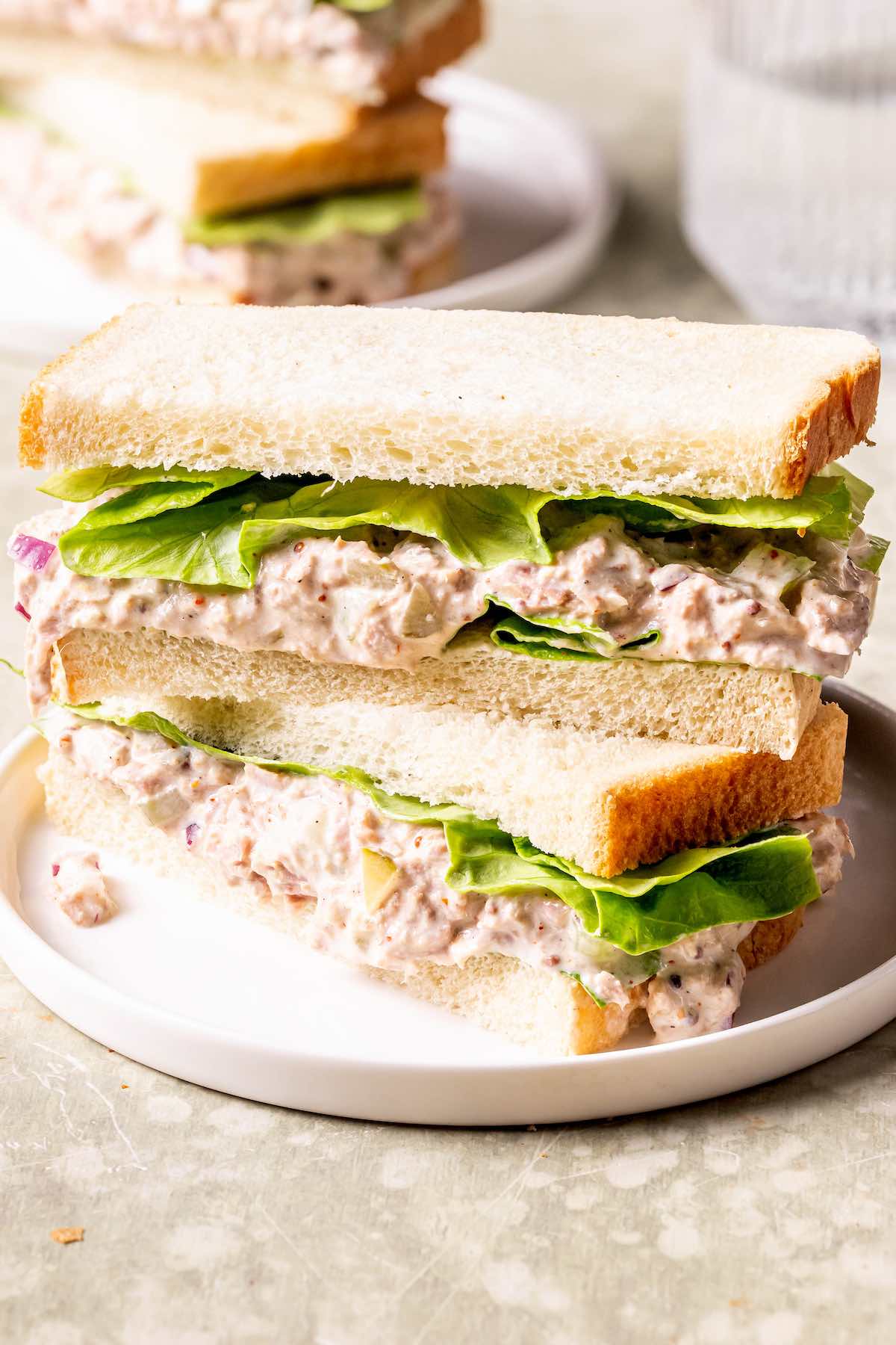 healthy tuna salad in between slices of white bread.