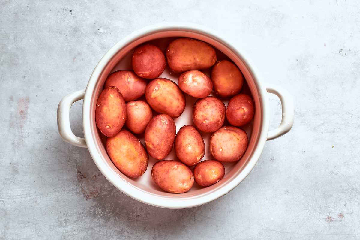 raw potatoes boiling in a pot.