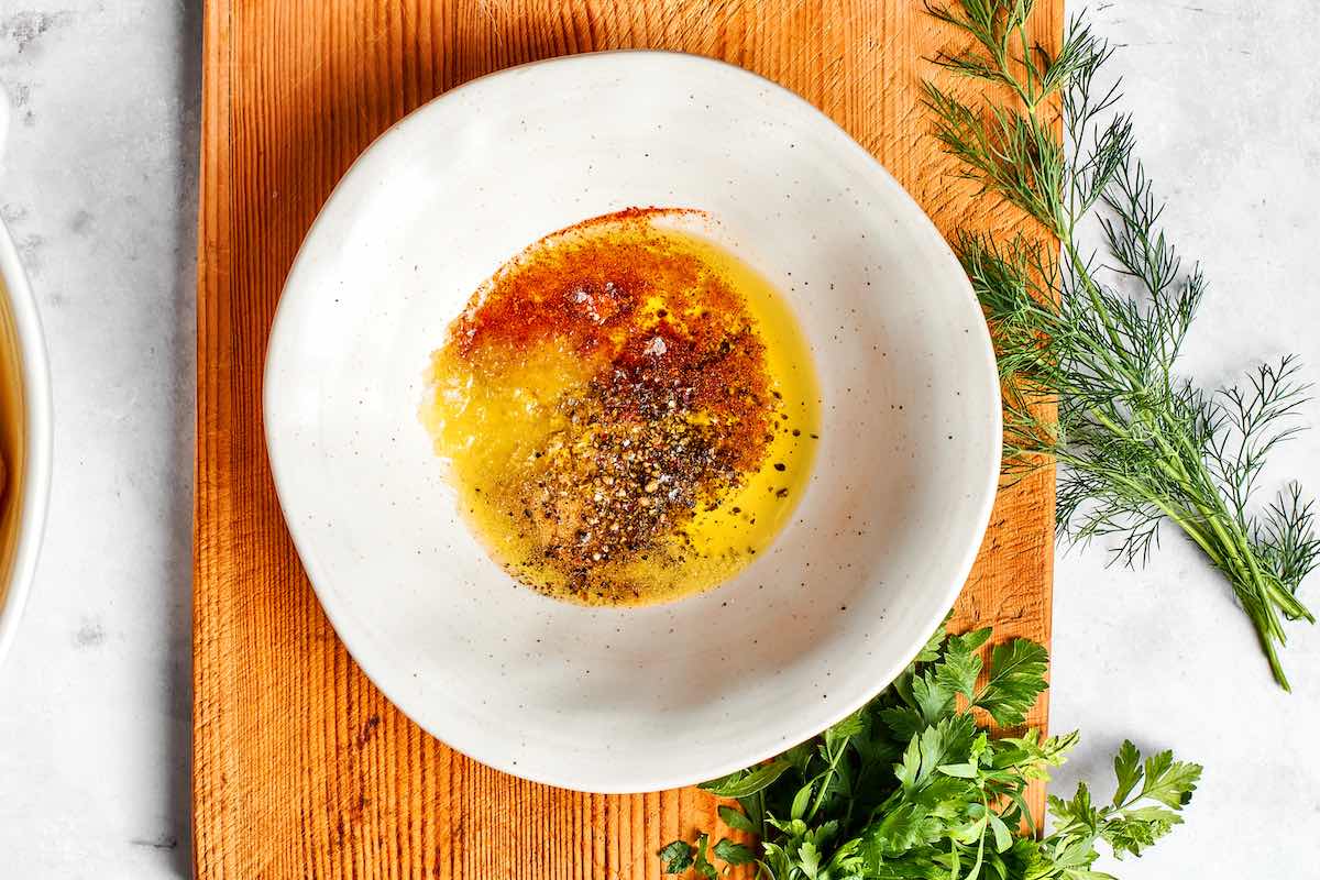 olive oil, smoked paprika, salt, and pepper in a bowl.