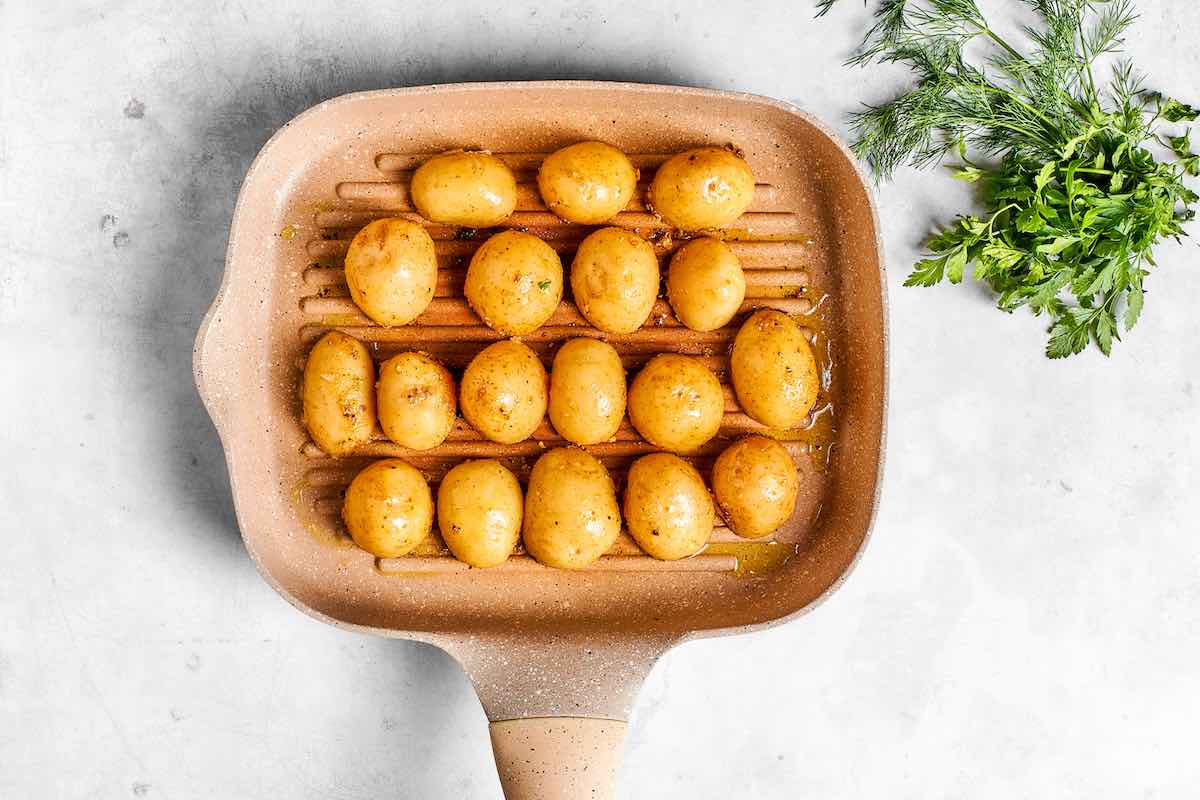 seasoned potatoes on a grill.
