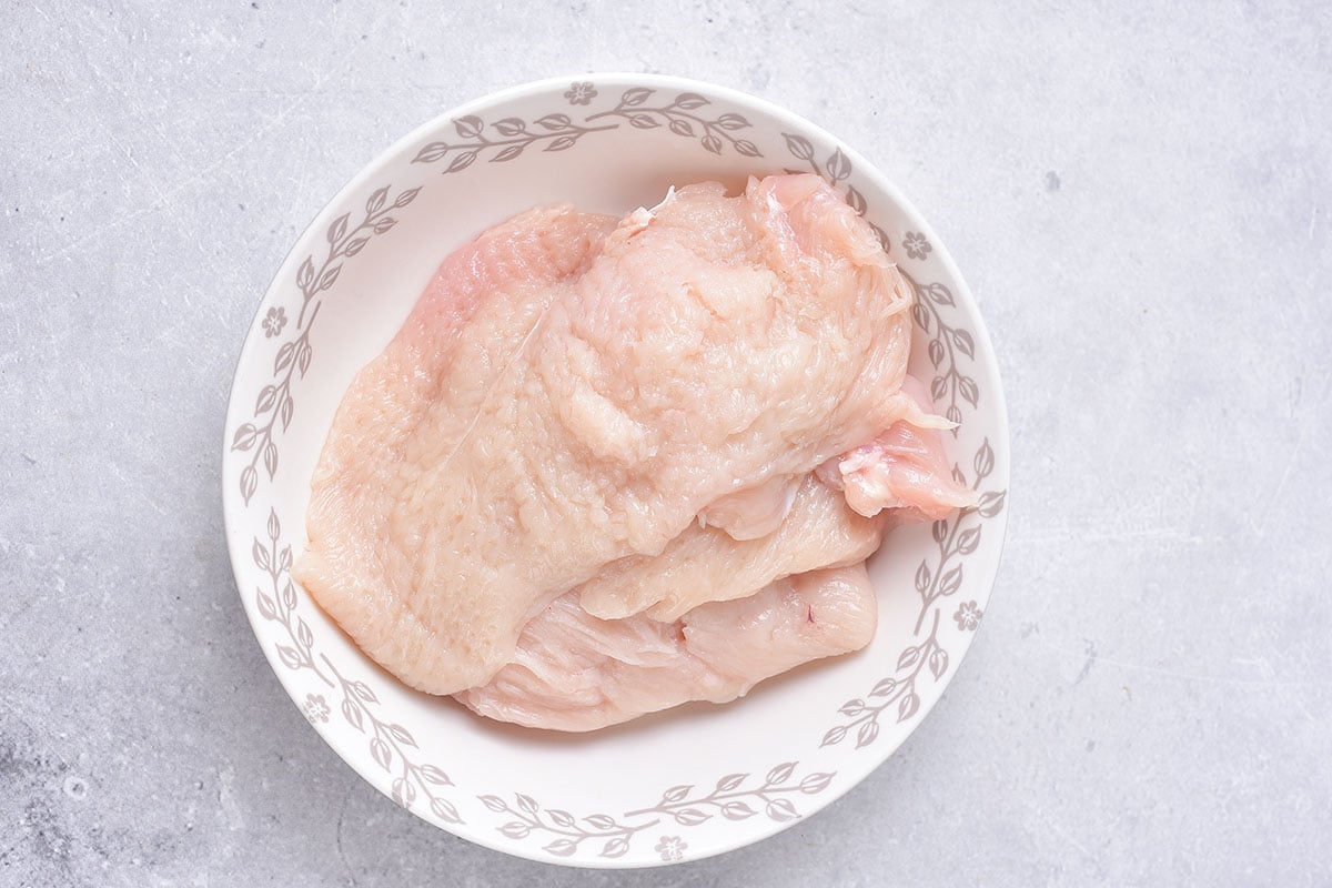 flattened raw chicken cutlets.