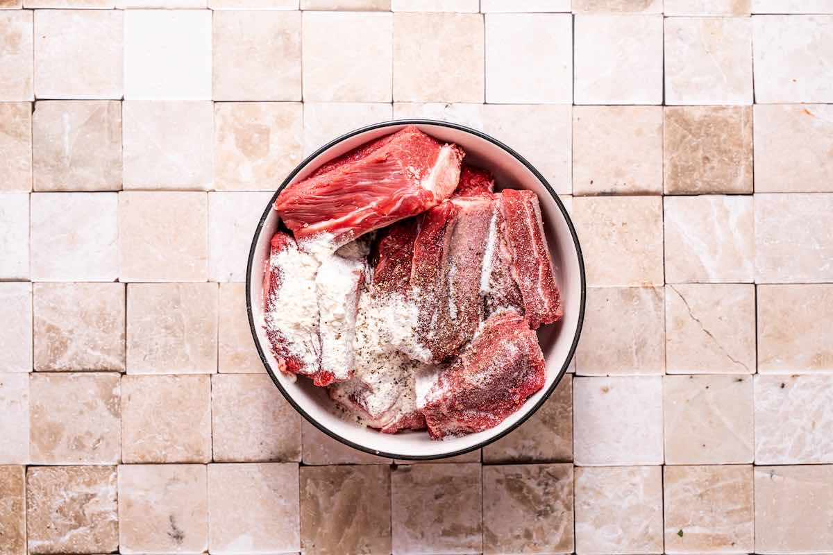 raw beef chuck short ribs tossed in salt, pepper, and flour.
