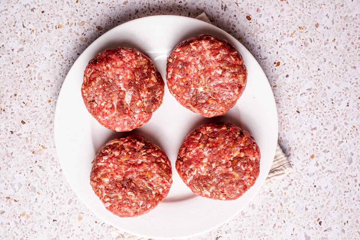 shaped raw bison burgers.
