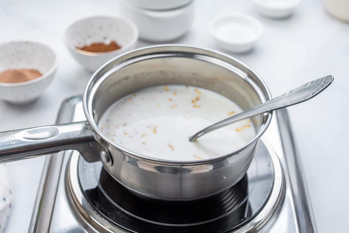oats and milk simmering in a saucepan.