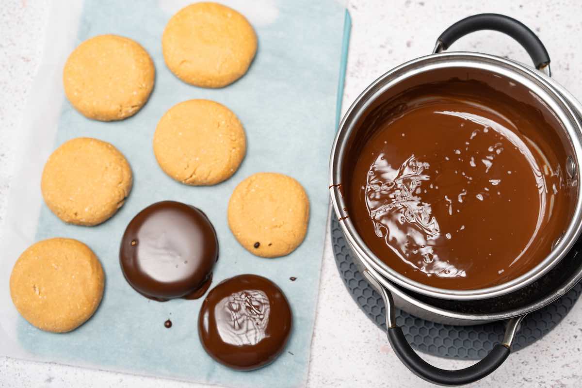 dipping no bake cookies in melted chocolate.