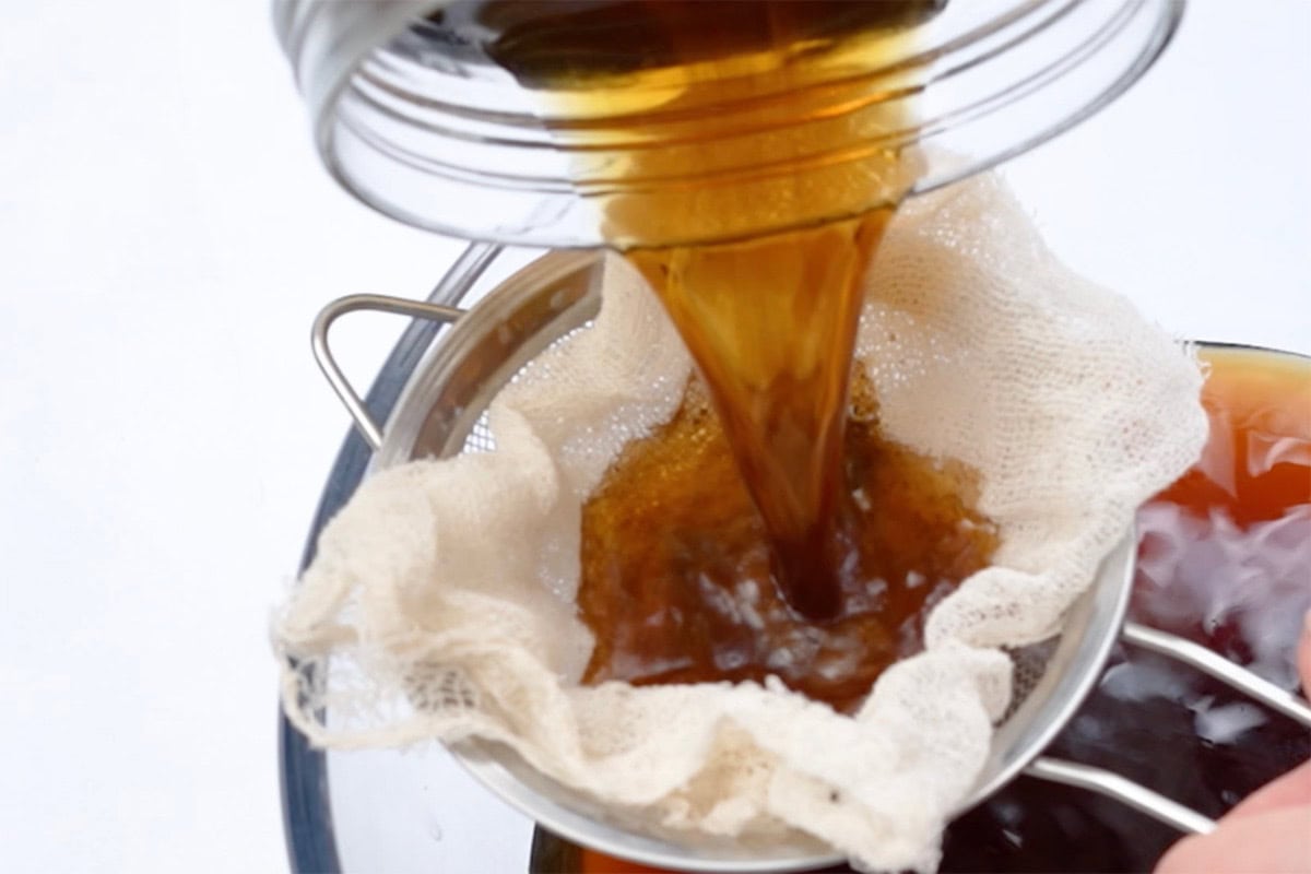 sieving coffee in a cheesecloth.