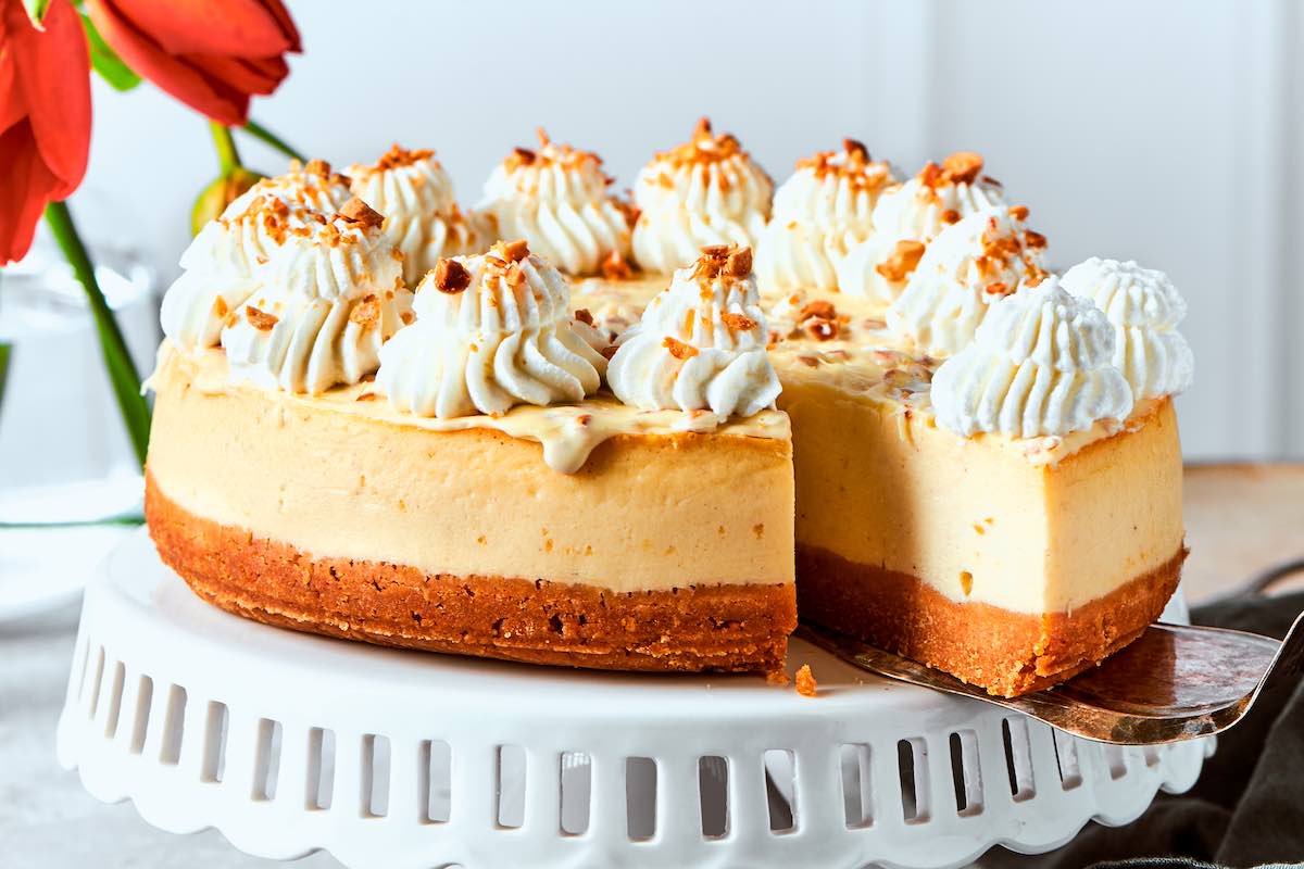 baked cottage cheese cheesecake with whipped cream on top.