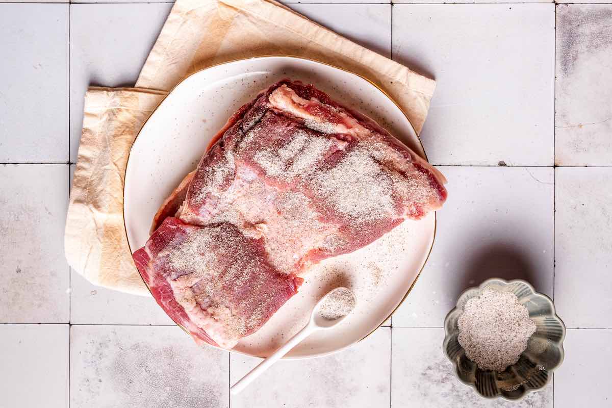 seasoned raw pork belly with salt and pepper.