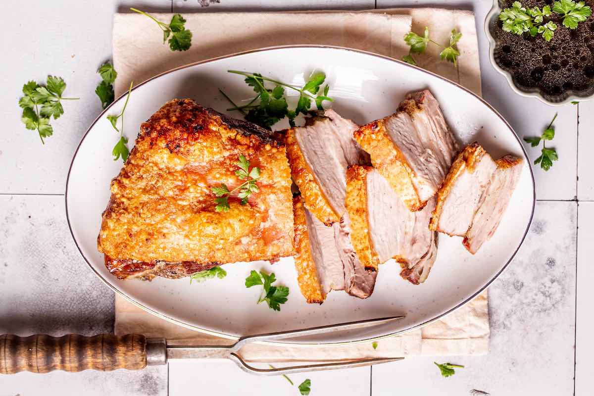sliced crispy pork belly on a plate.
