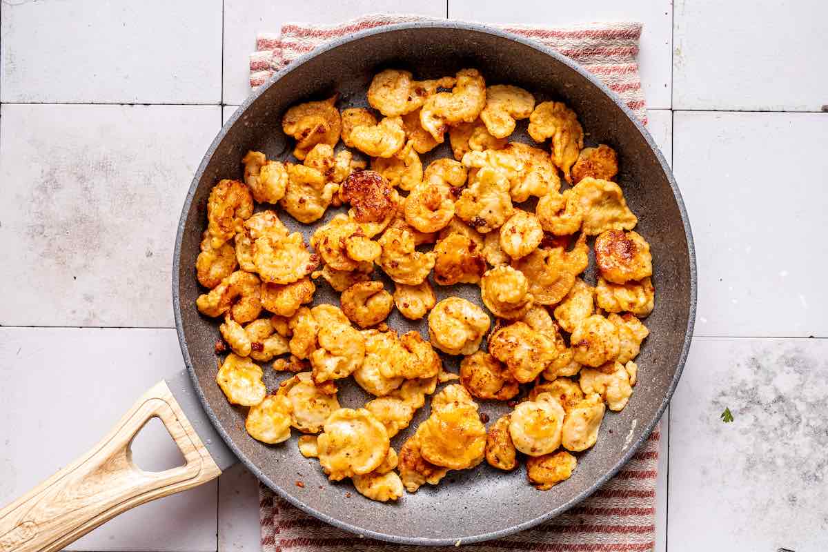 pan-fried crispy shrimp in a skillet.