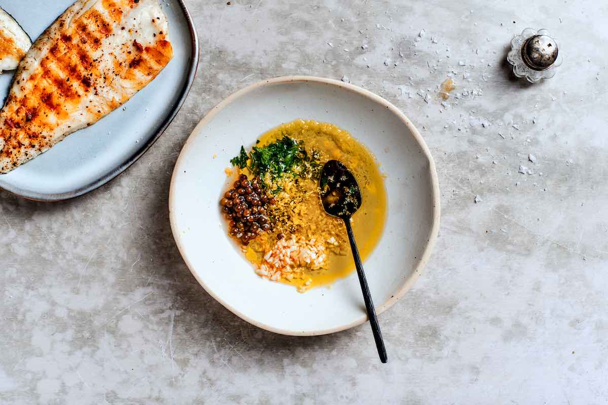garlic, olive oil, peppercorns, lemon zest, and parsley in a bowl.
