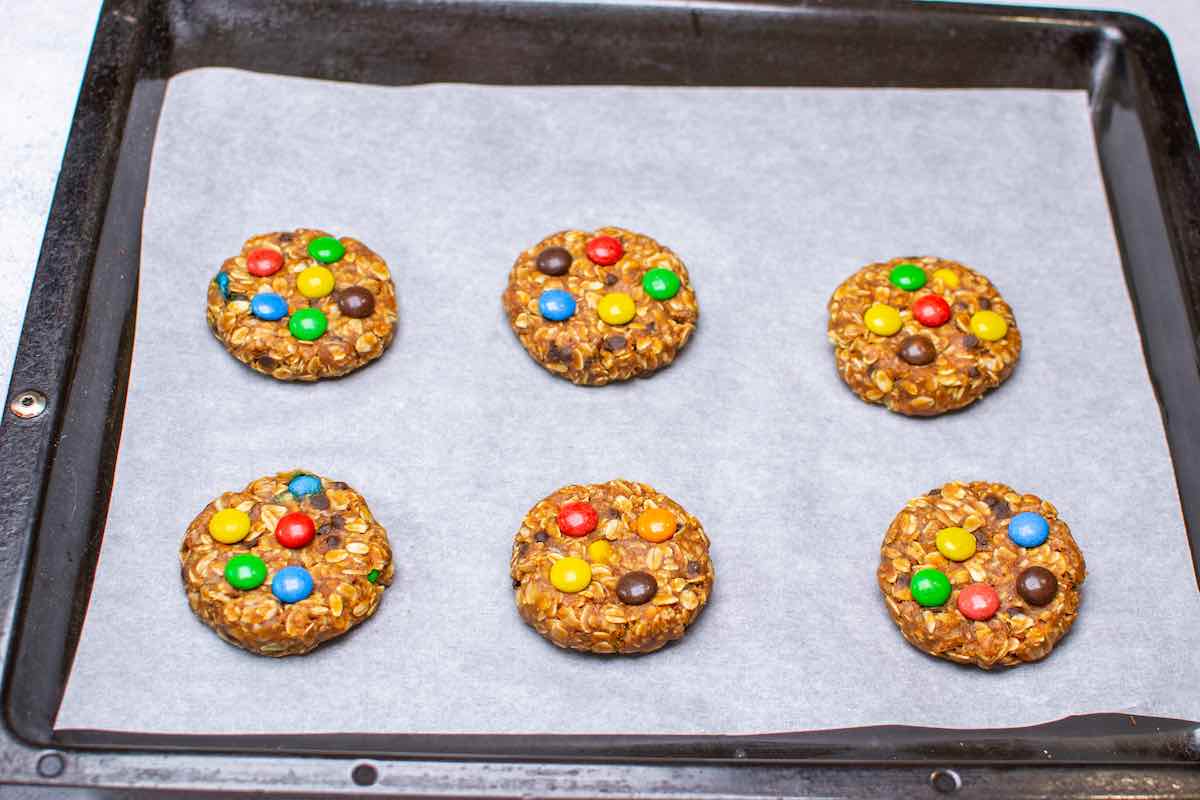 baked monster cookies on a baking sheet.