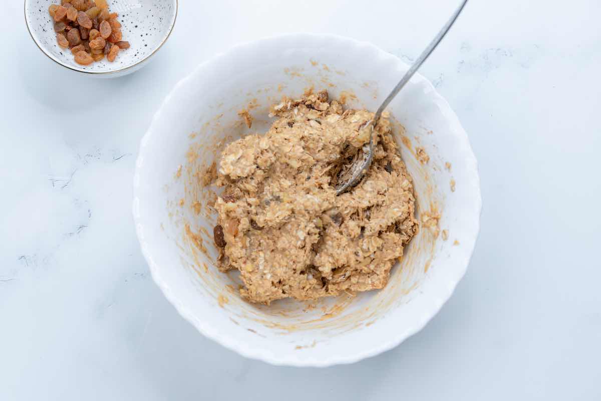 mixing bowl with oats, banana, raisins, and almond butter.
